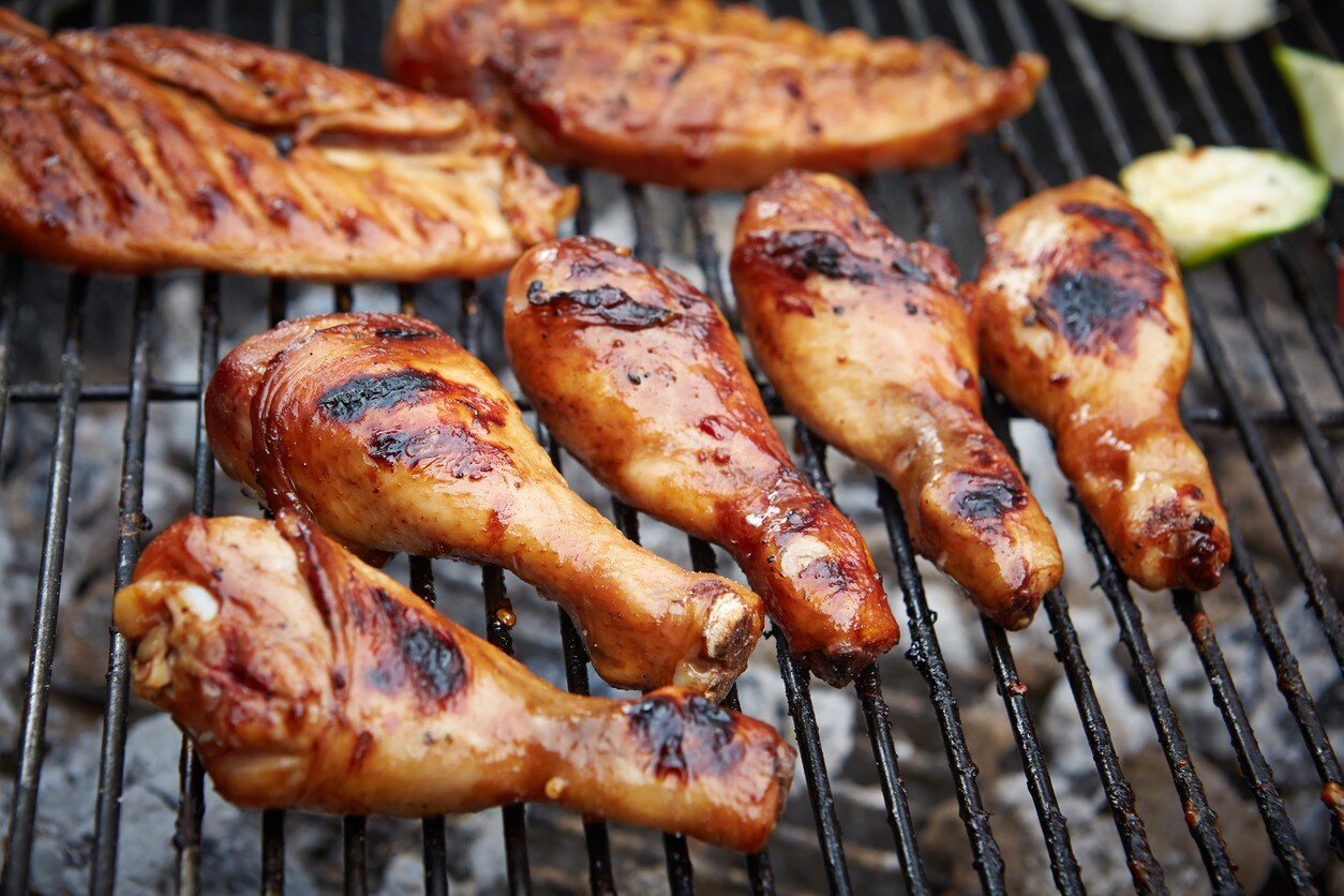 Grelha sobre brasas, com coxas e filés de peito de frango em processo de defumação. Grelha sobre brasas, com coxas e filés de peito de frango em processo de defumação.